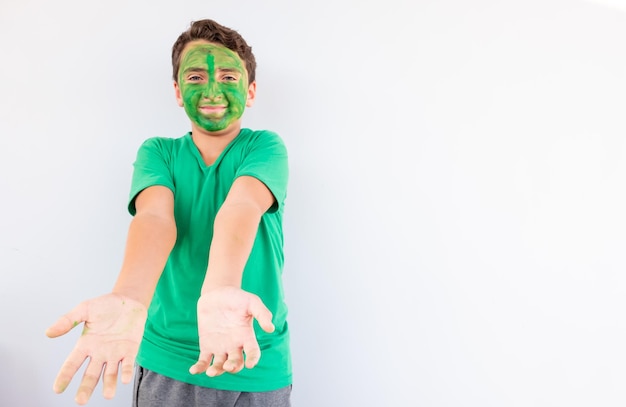 Boy playing with colors using his hands and his face