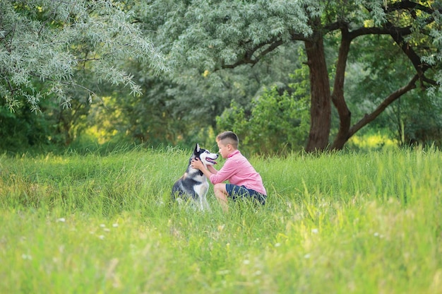 Boy playing with dog for nature ground