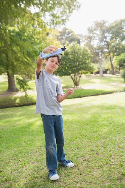 Boy playing with a toy plane at park