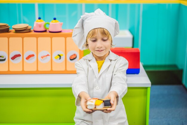 Boy plays the game as if he were a cook in a children's kitchen