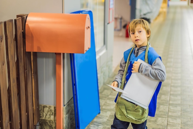 The boy plays that he is a postman