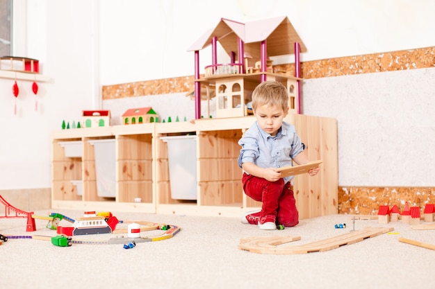 Boy plays with train