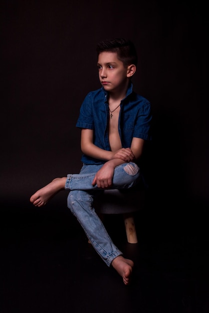 Boy posing on a black background  closeup