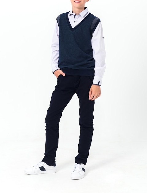 Boy posing in school uniform on white background Vertical photo