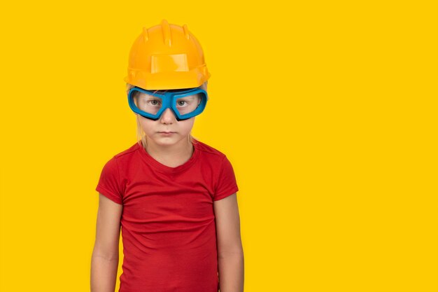 Boy in protective helmet and safety glasses