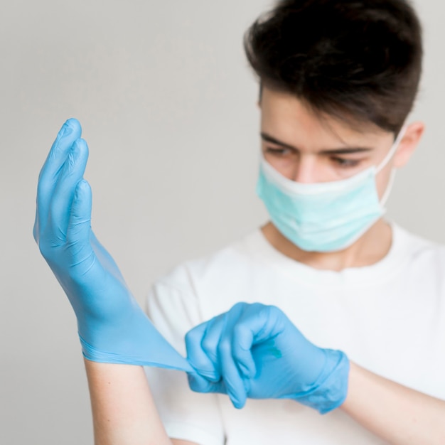 Boy putting on gloves