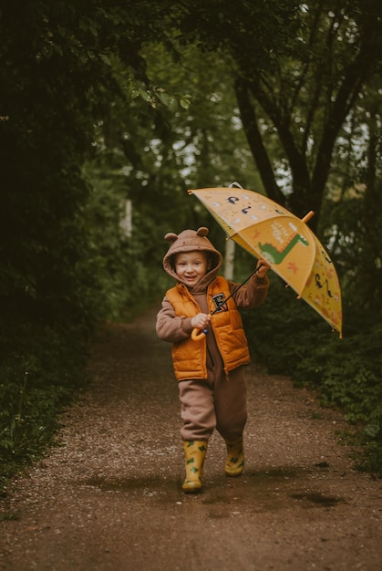 a boy in the rain a child with an umbrella nature