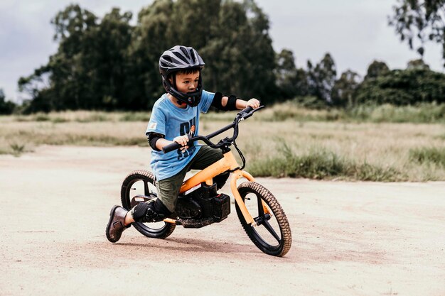 boy riding bicycle on field