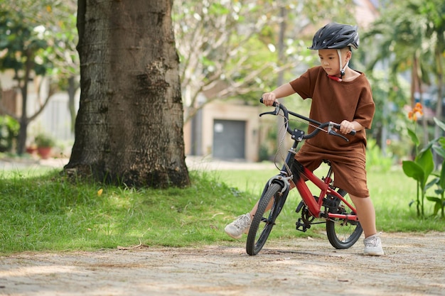 Boy Riding Bicycle in Park