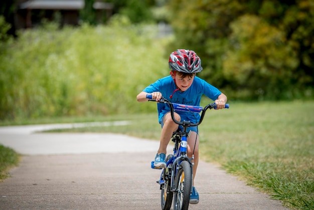 boy riding bicycle on road