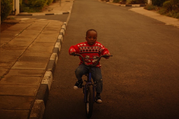 Boy riding bicycle on street