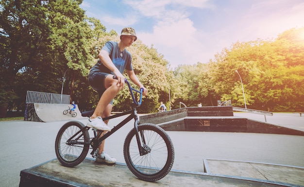 Boy riding a bmx in a park.