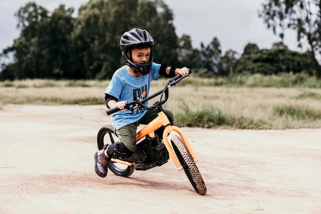 boy riding push scooter on road