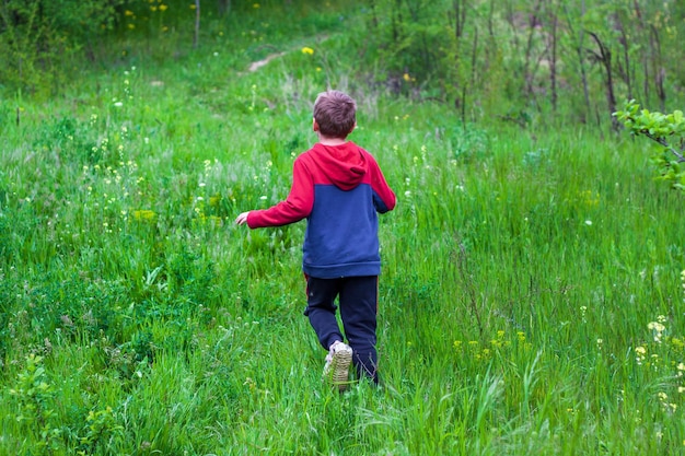 the boy runs through the grass