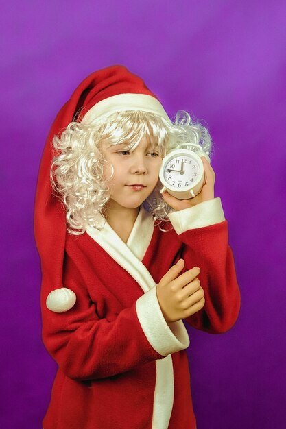 A boy in a santa claus costume