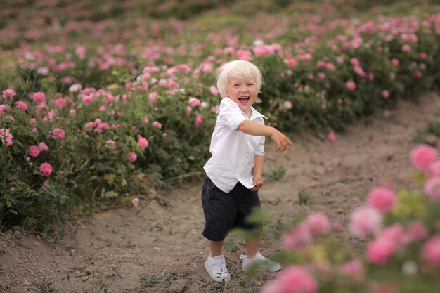 Boy screams and points finger at blossoming flowers