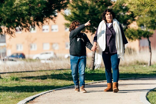 Boy and senior woman on footpath