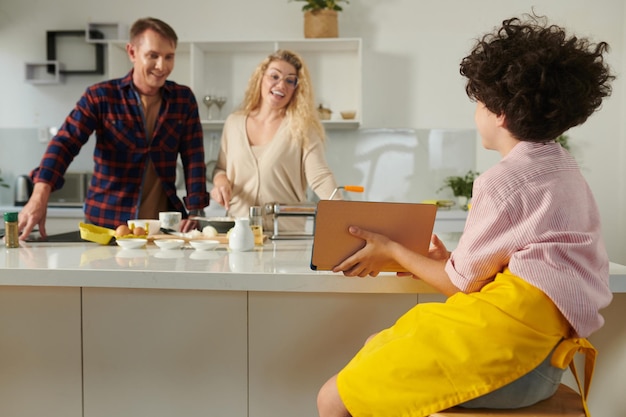 Boy Showing Video Recipe to Parents