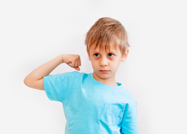 Boy shows strength.little boy of five shows his muscles