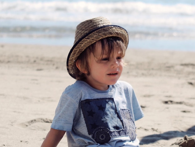 Boy sitting on beach