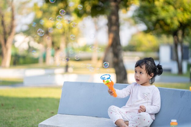 Boy sitting on grass in park