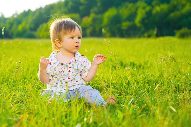 Boy sitting on the grass.