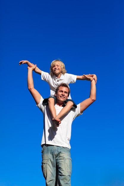 Boy sitting on his father's shoulders