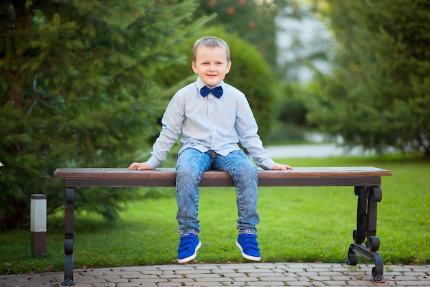 Boy sitting in the Park on a bench