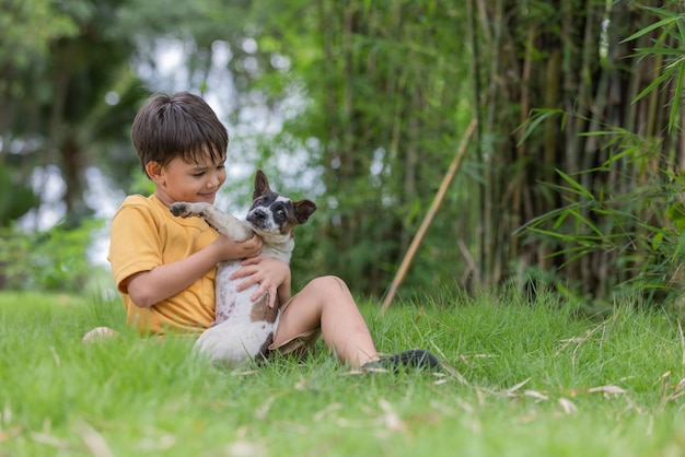 Boy sitting at park with dog
