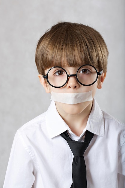 Boy of six years old with closed mouth. Closeup