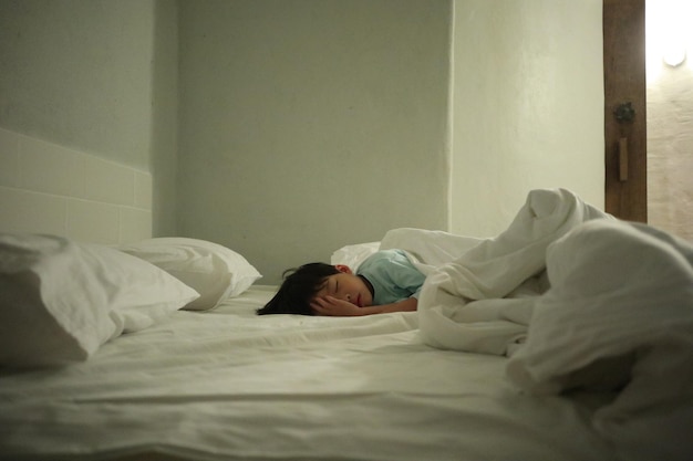 Boy sleeping on bed