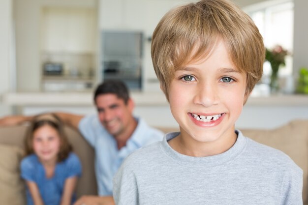 Boy smiling with family in background