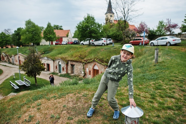 Boy stand at traditional wine cellars outdoor in Vrbice Czech Republic