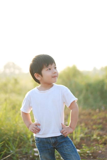boy standing on field against clear sky