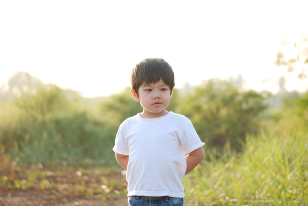boy standing on field against sky
