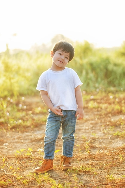 boy standing on field against sky