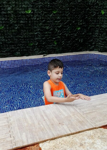 Boy standing in swimming pool