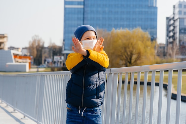 A boy stands in a mask during a quarantine