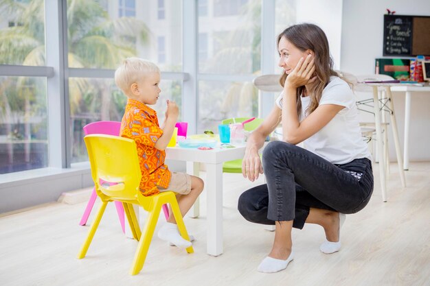 Boy staring at his teacher awkwardly while eating