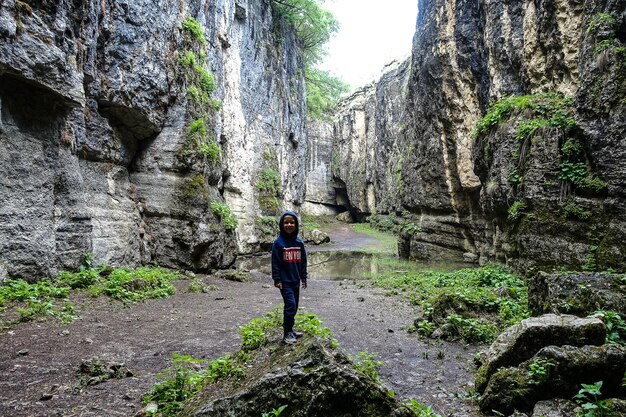 A boy in the Stone Bowl Gorge A gorge in the mountains of the landscape nature of Dagestan Russia