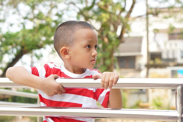 The boy stood on the corridor leading up to the building