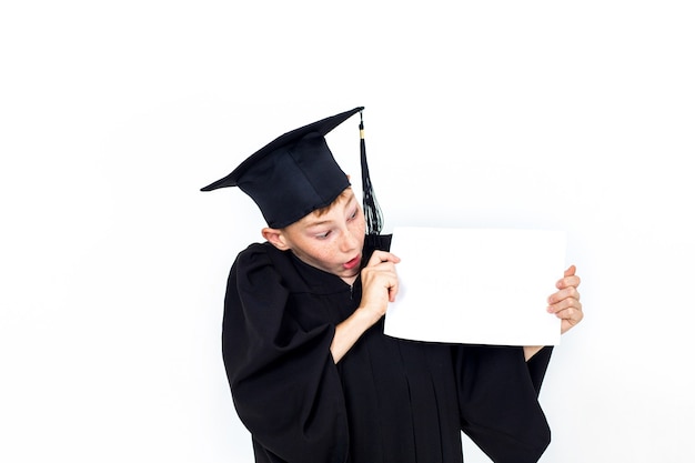 A boy in a student hat holding an empty Billboard