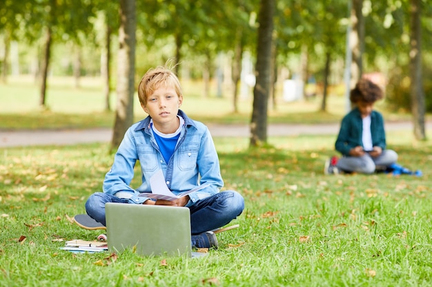 Boy studying online outdoors