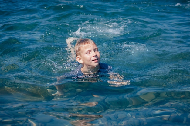 写真 湖で泳ぐ少年