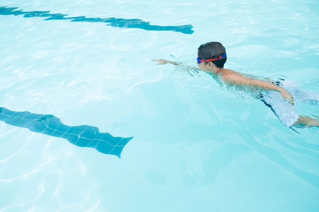 Boy swimming in the pool at the leisure center