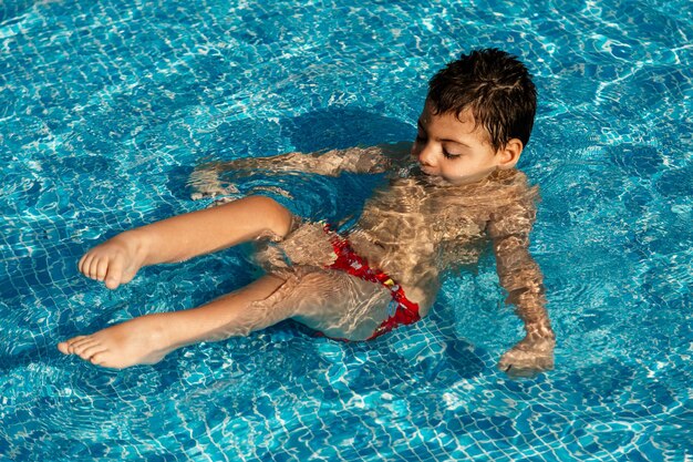 Boy swimming in pool