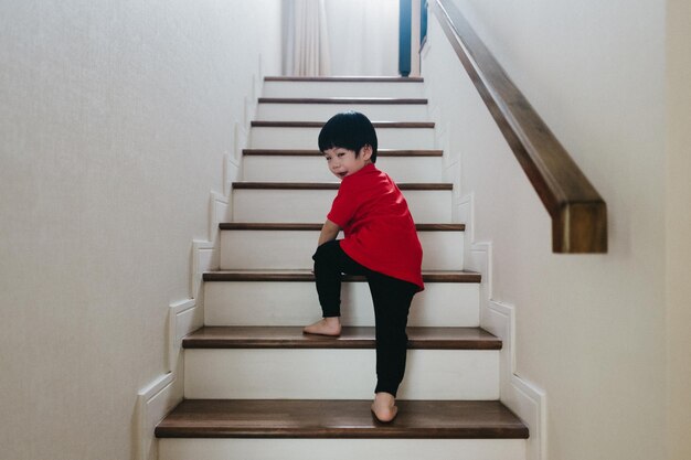 Photo boy taking up the stair