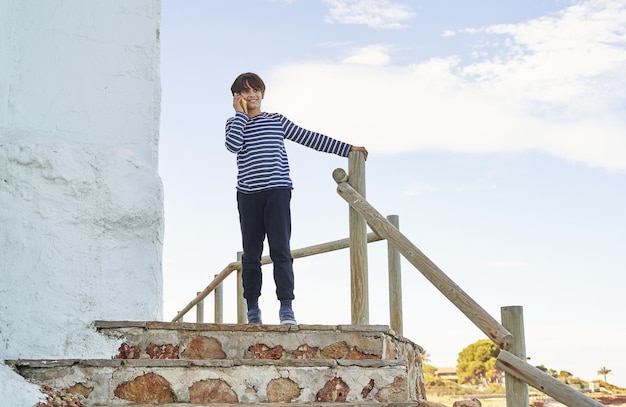 The boy talking on the mobile phone