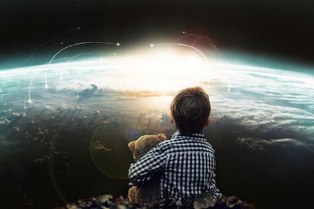 Photo boy teddy bear and nuclear war and apocalypse of violence planet and explosion in space innocent child looking and fear of strike on earth brutal and invasion of danger weapons and disaster