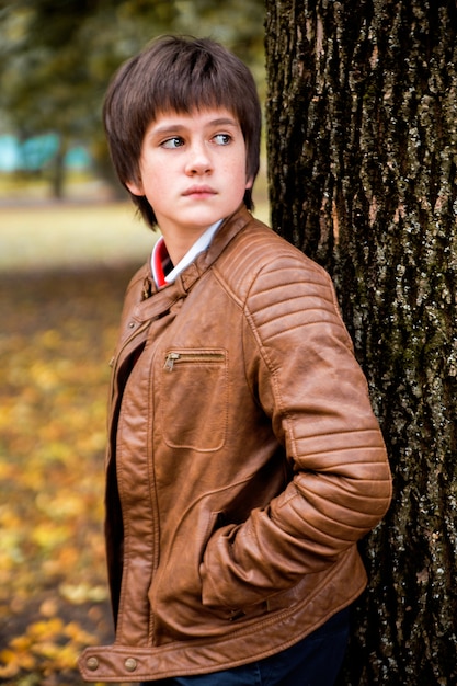 Boy teenager in autumn forest